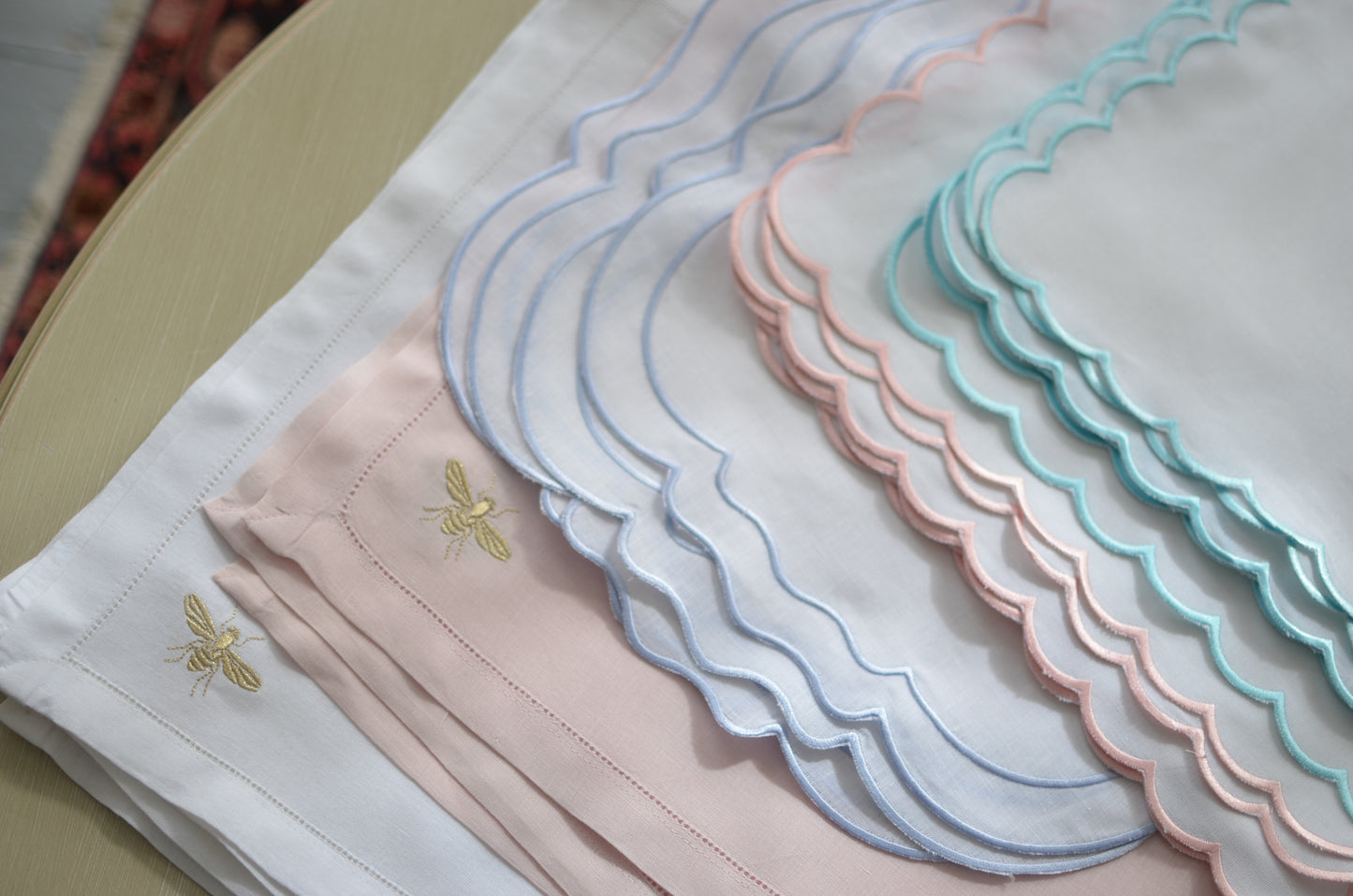 White cotton napkin with a turquoise scalloped edge