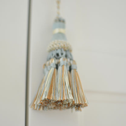 Light blue cream & copper tassel