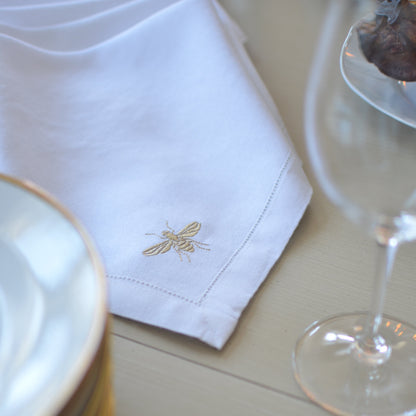White cotton napkin with a bumblebee motif