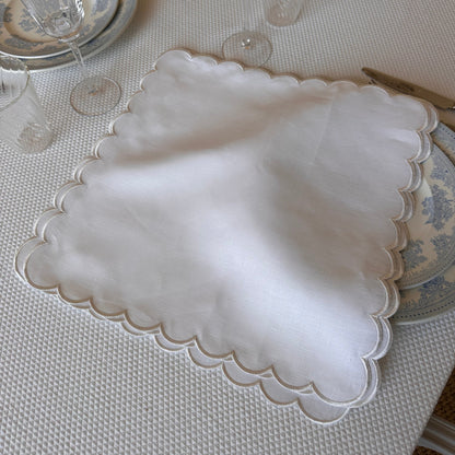 White linen napkin with a white scalloped edge