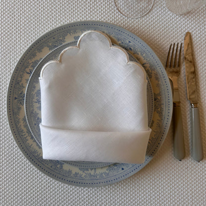 White linen napkin with a white scalloped edge