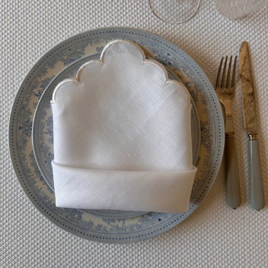 White linen napkin with a white scalloped edge