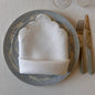 White linen napkin with a white scalloped edge