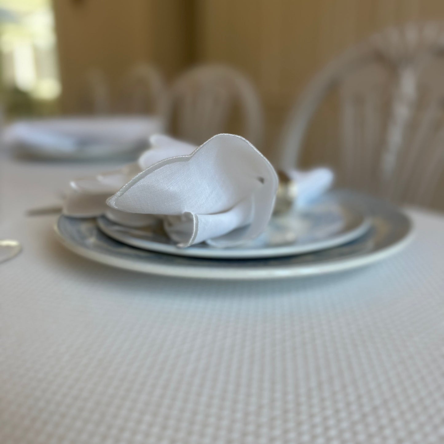 White linen napkin with a white scalloped edge
