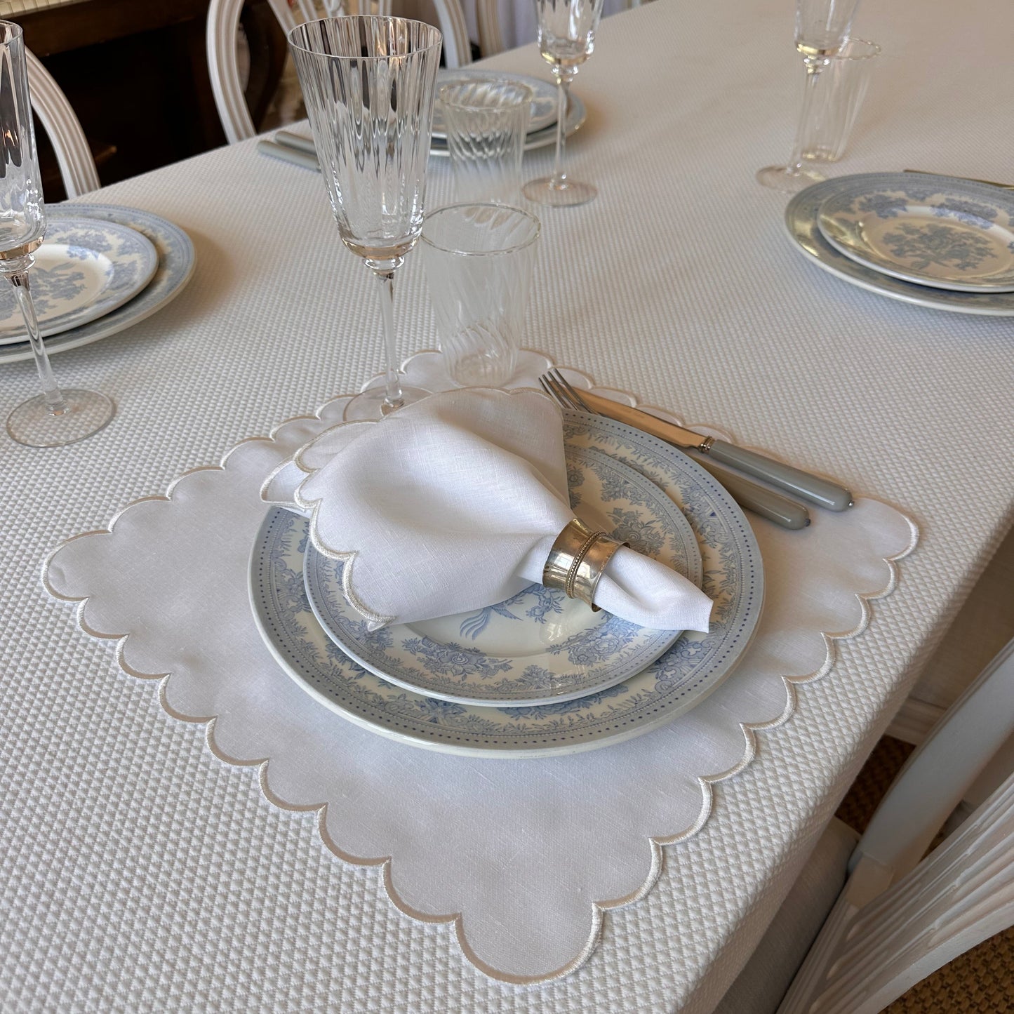 White linen napkin with a white scalloped edge