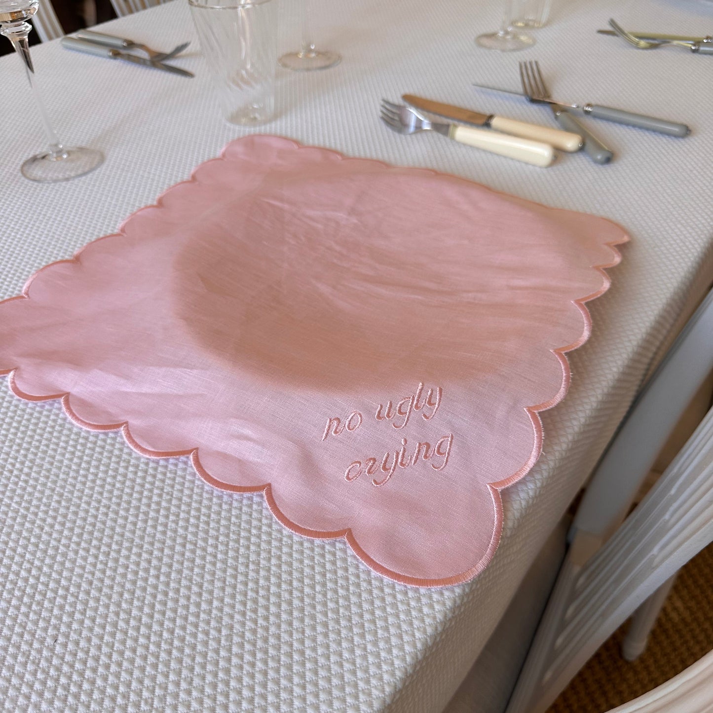 Monogrammed pink linen napkin with a pink scalloped edge