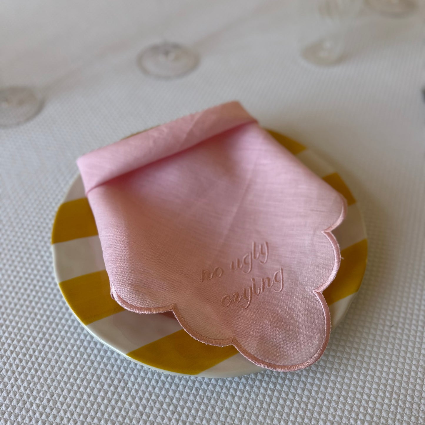 Monogrammed pink linen napkin with a pink scalloped edge