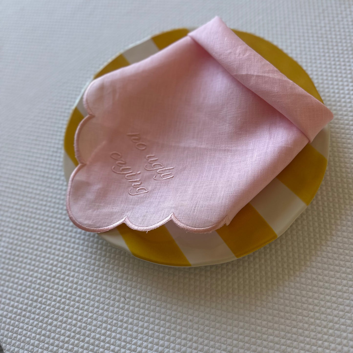Monogrammed pink linen napkin with a pink scalloped edge