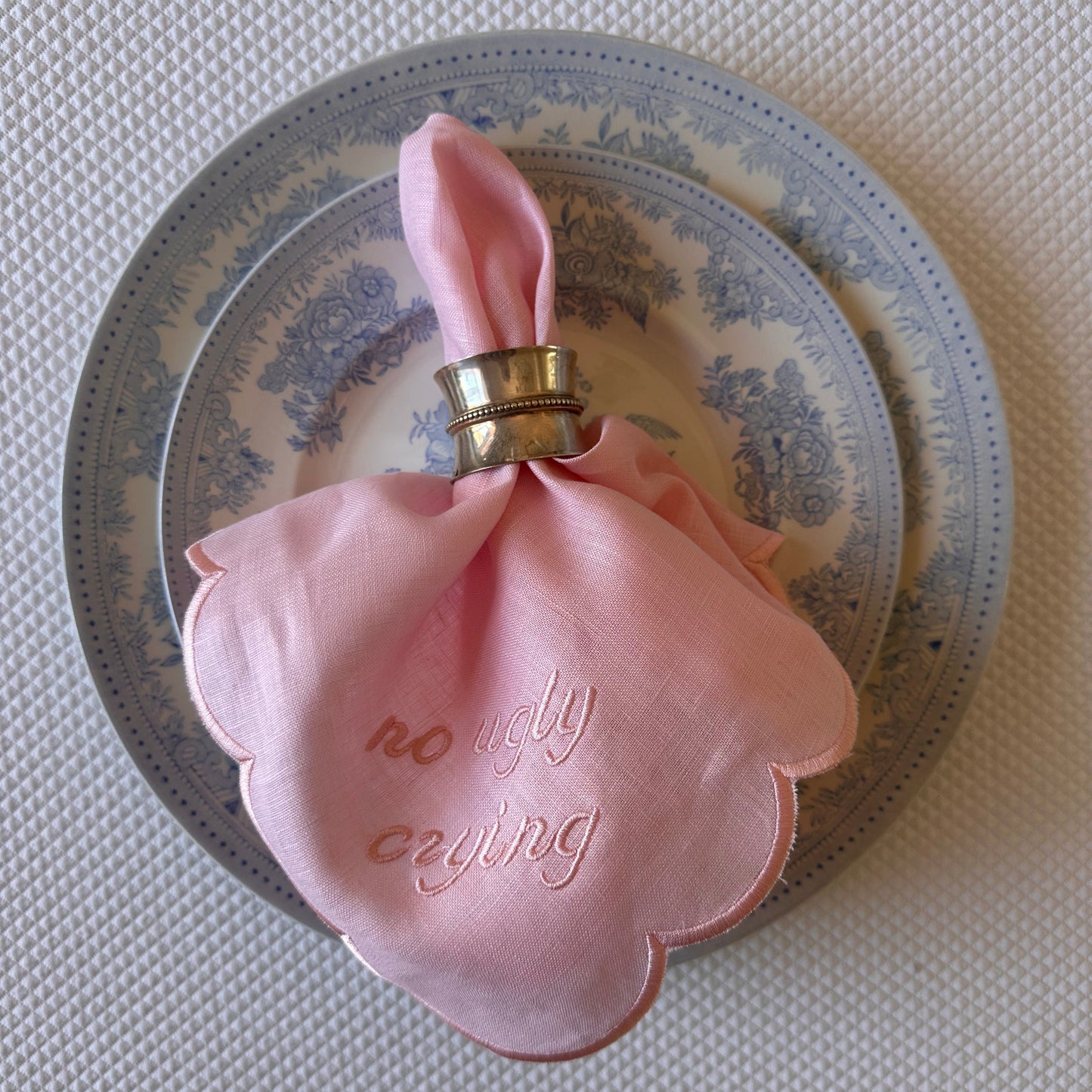 Monogrammed pink linen napkin with a pink scalloped edge