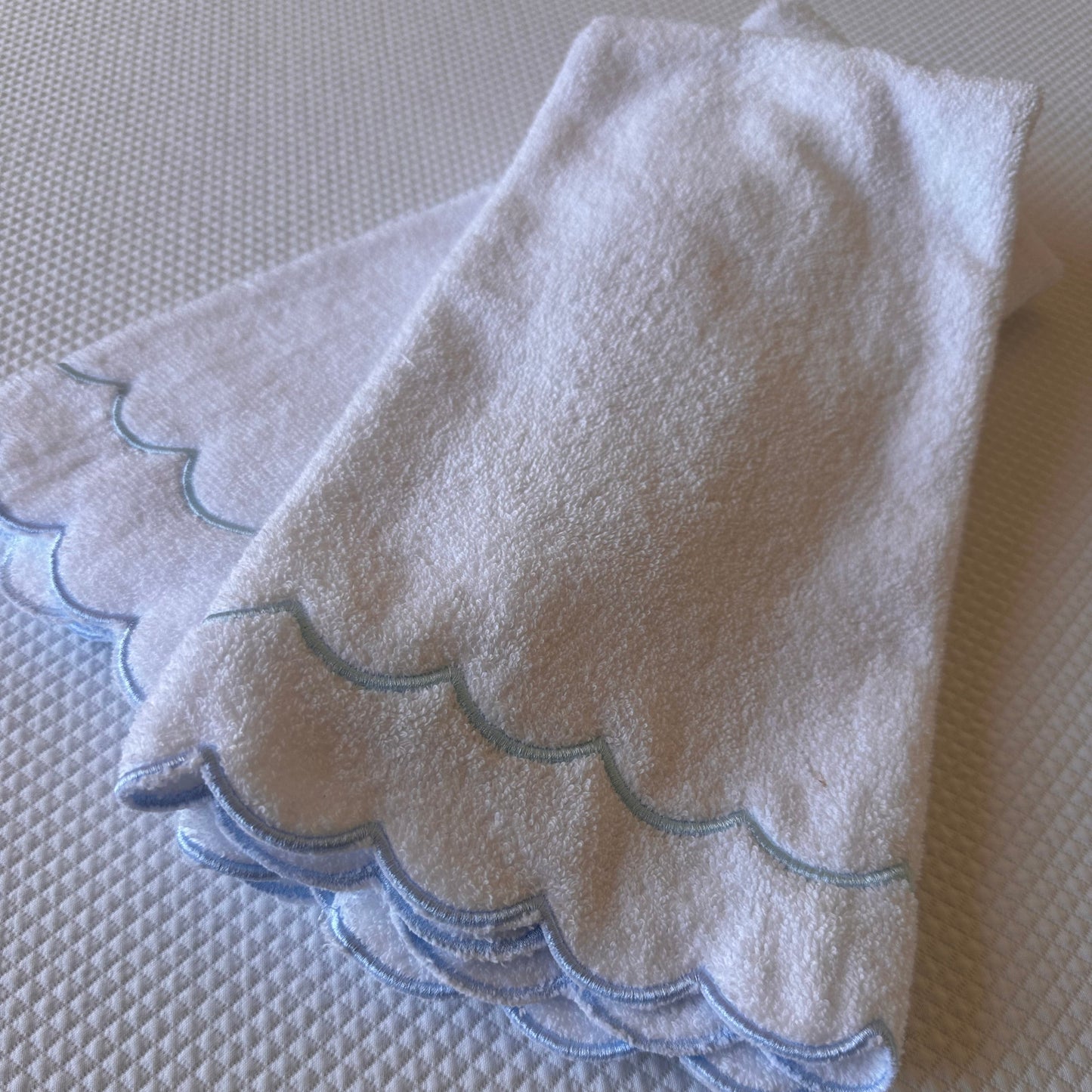 A scalloped edge hand towel set of two
