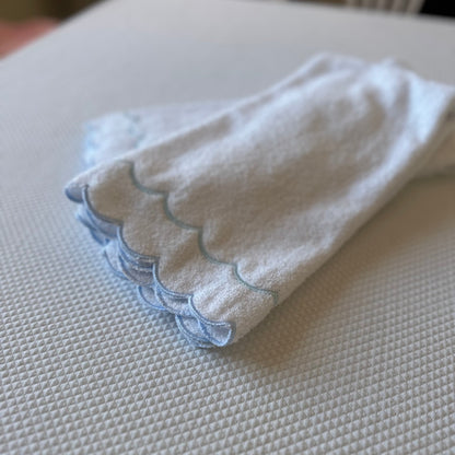 A scalloped edge hand towel set of two