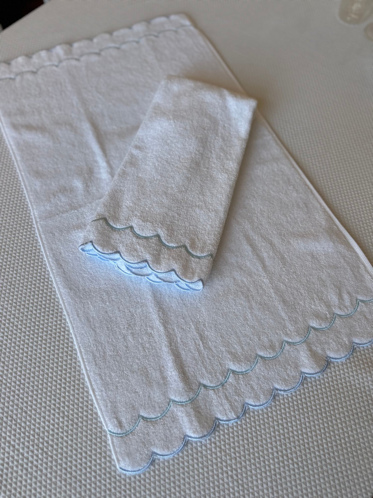 A scalloped edge hand towel set of two