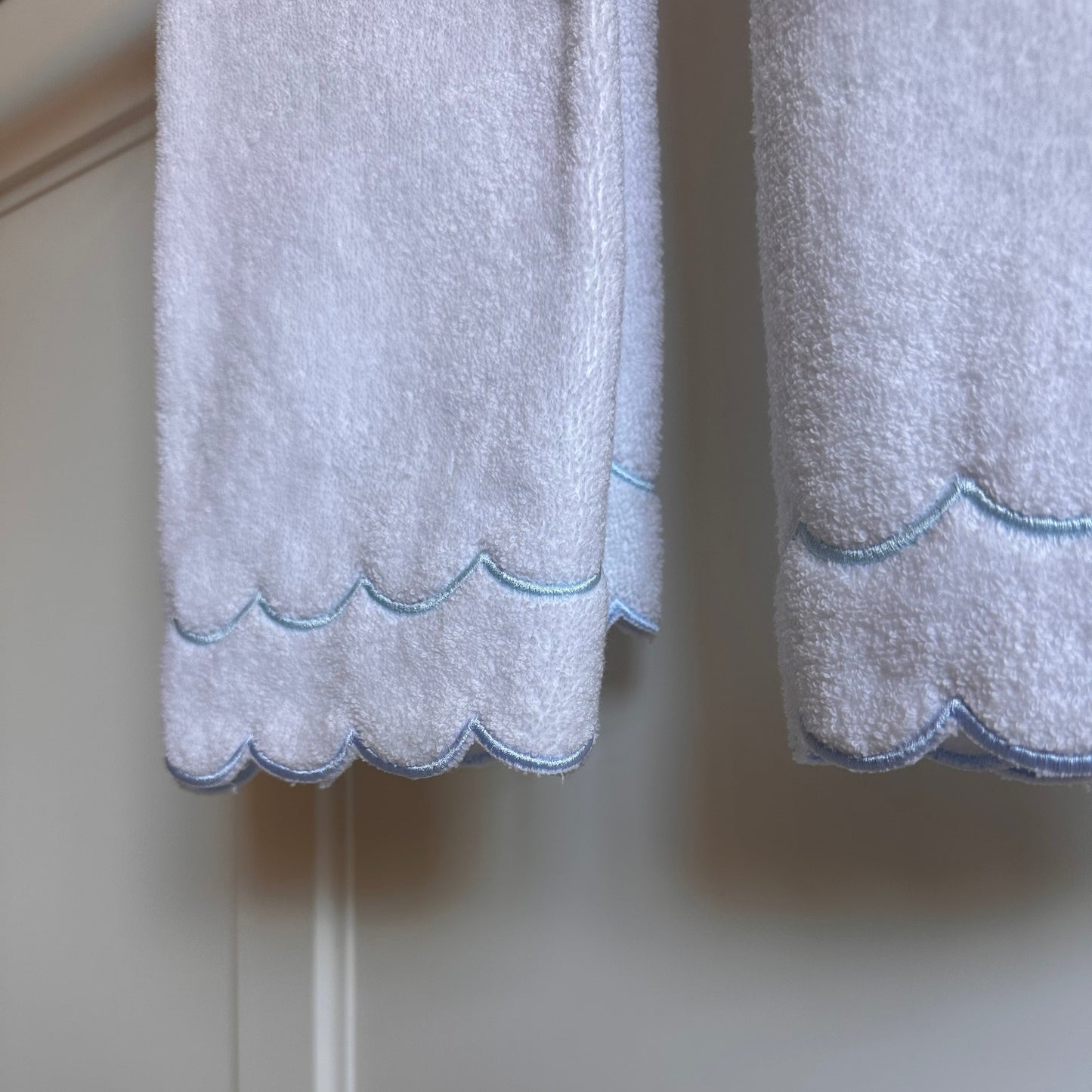 A scalloped edge hand towel set of two